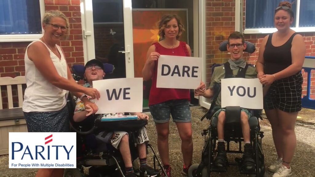 Students and staff holding up signs saying We Dare You