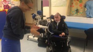 Student laughing at bouncing ping pong balls